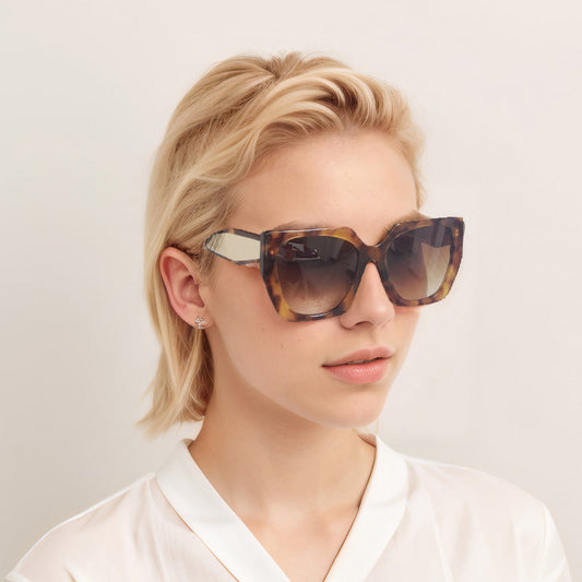 Woman wearing Lenoir Brest sunglasses in tortoiseshell acetate