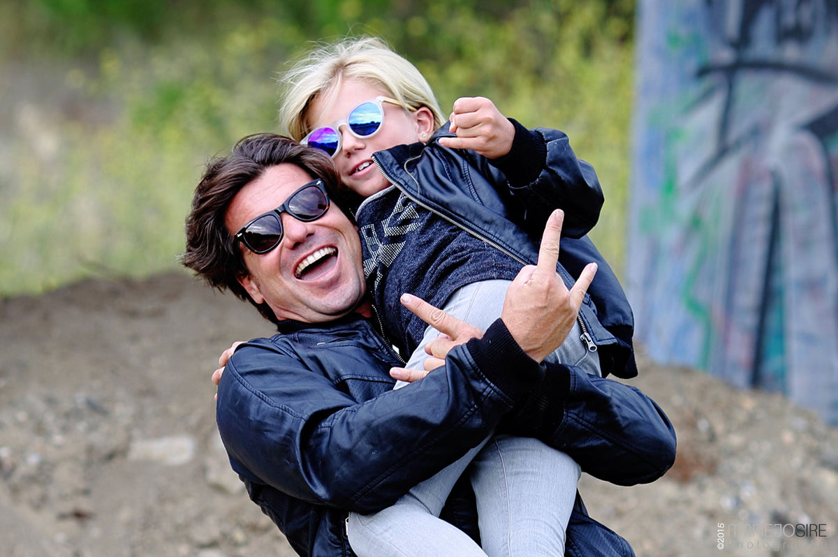 Two friends laughing, both wearing Lenoir sunglasses